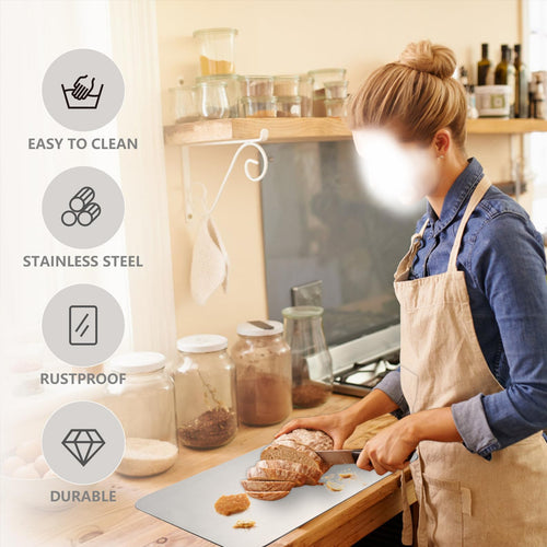 Home cook preparing food on a stainless steel cutting board in a kitchen